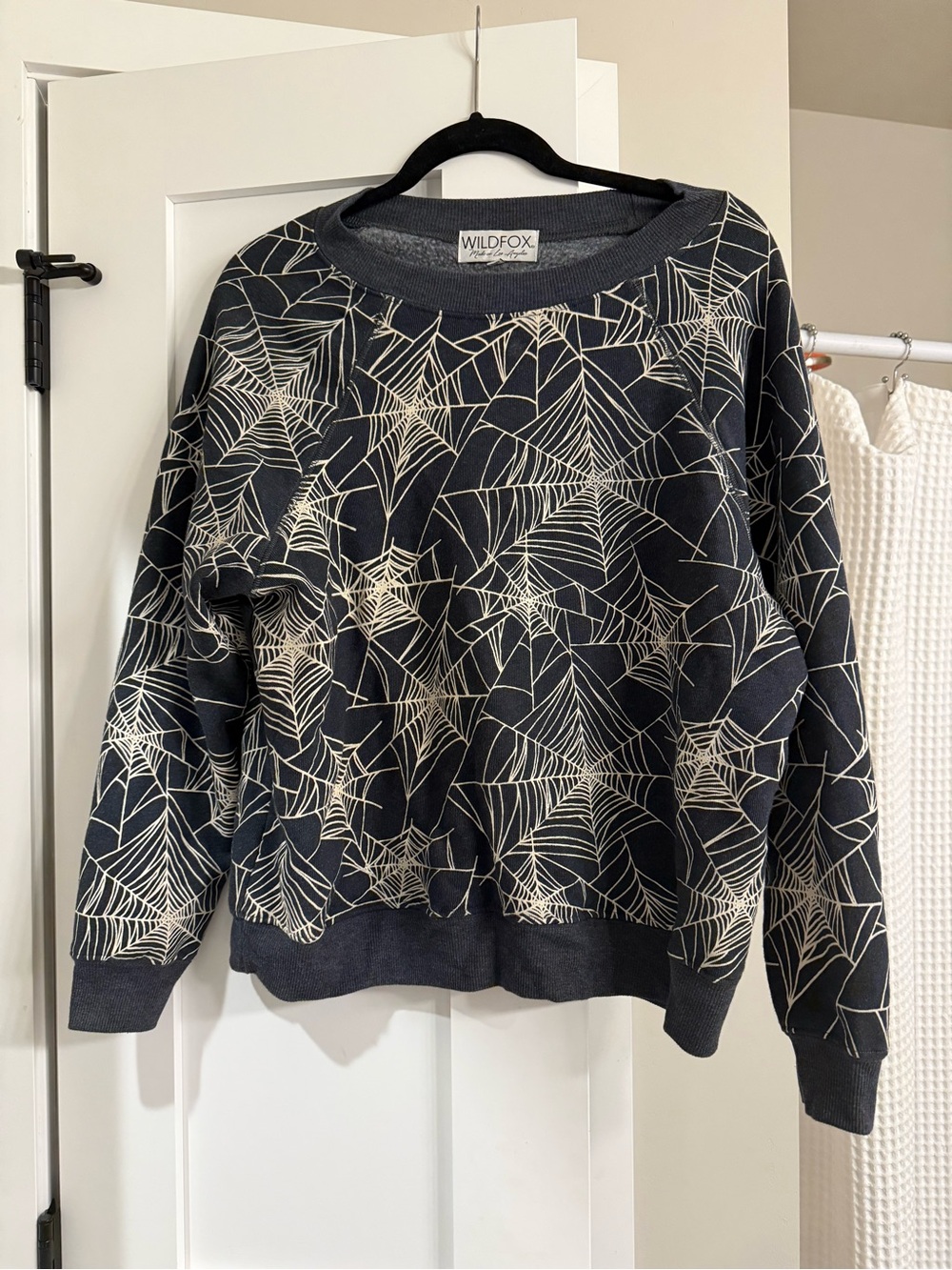 Wildfox Black Crewneck Sweater with Cream Spiderweb Print- glow in the dark